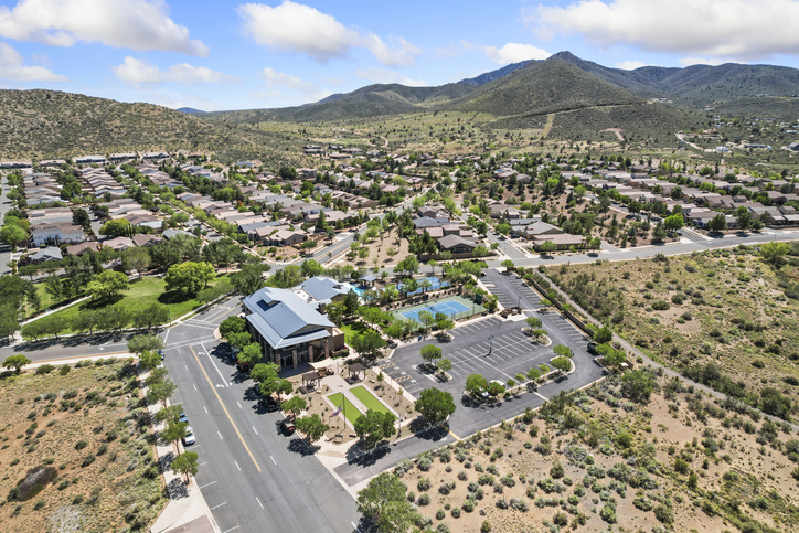 Aerial view of suburban landscape and mountains.
